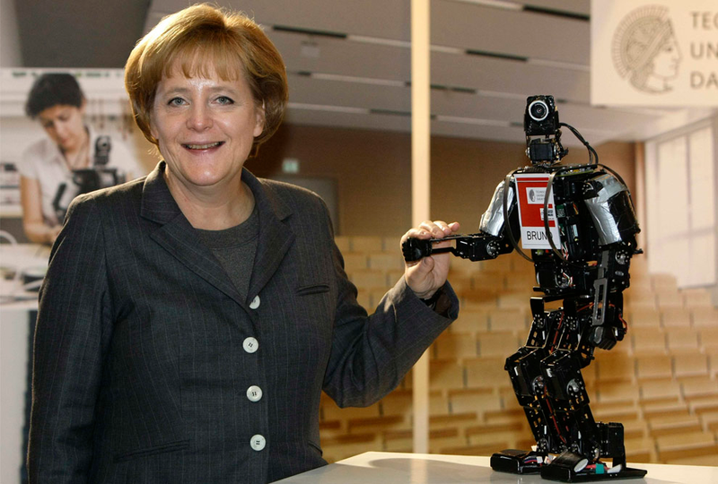 Illustration for article titled Why Is Angela Merkel Always Palling Around With Robots?